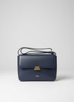 Navy blue handbag with gold clasp on a light gray background